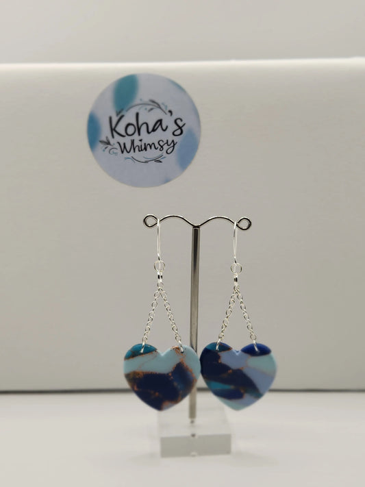 Blue heart dangle earrings from Koha's Whimsy on silver chains and earring hooks.