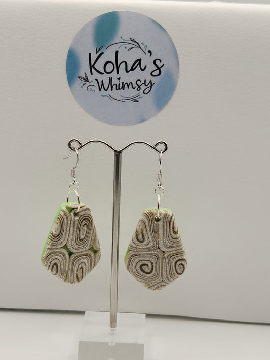 Close-up of cinnamon and lime earrings showing intricate swirl pattern and vibrant colour contrast
