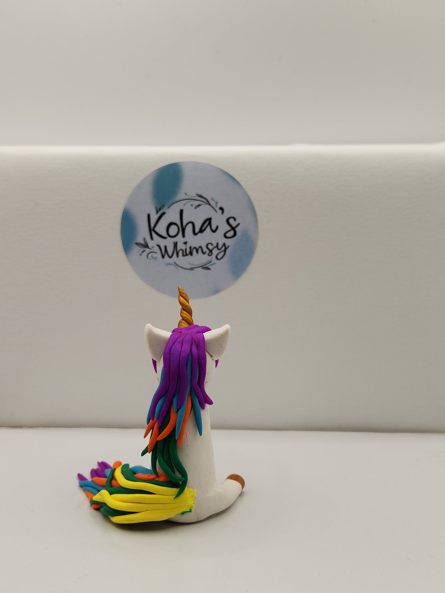 Gally the unicorn figurine shown from different angle highlighting whimsical desk companion design