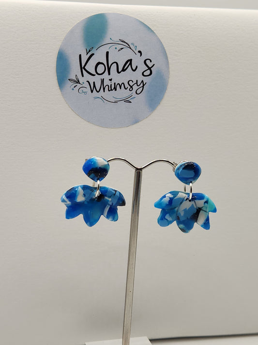 Handmade polymer clay lotus bloom stud earrings with navy burst design in blue and white
