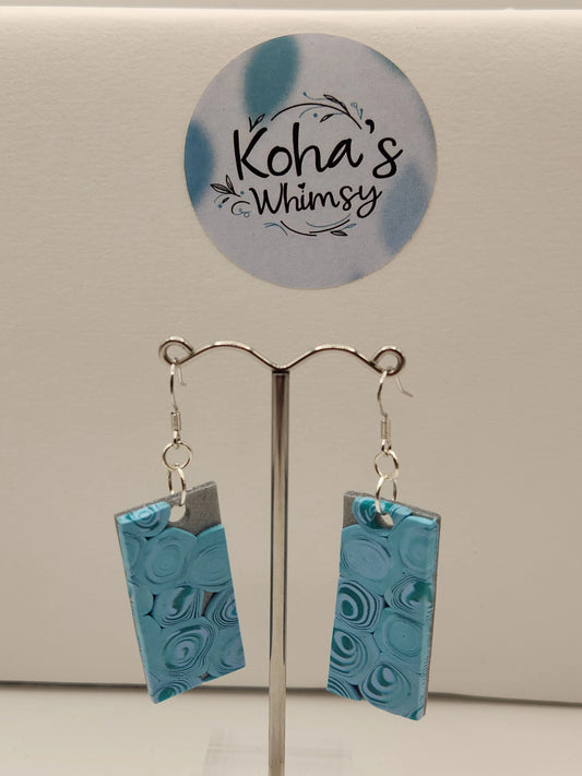 Teal swirl rectangle dangle earrings from Koha's Whimsy, with silver attachments.