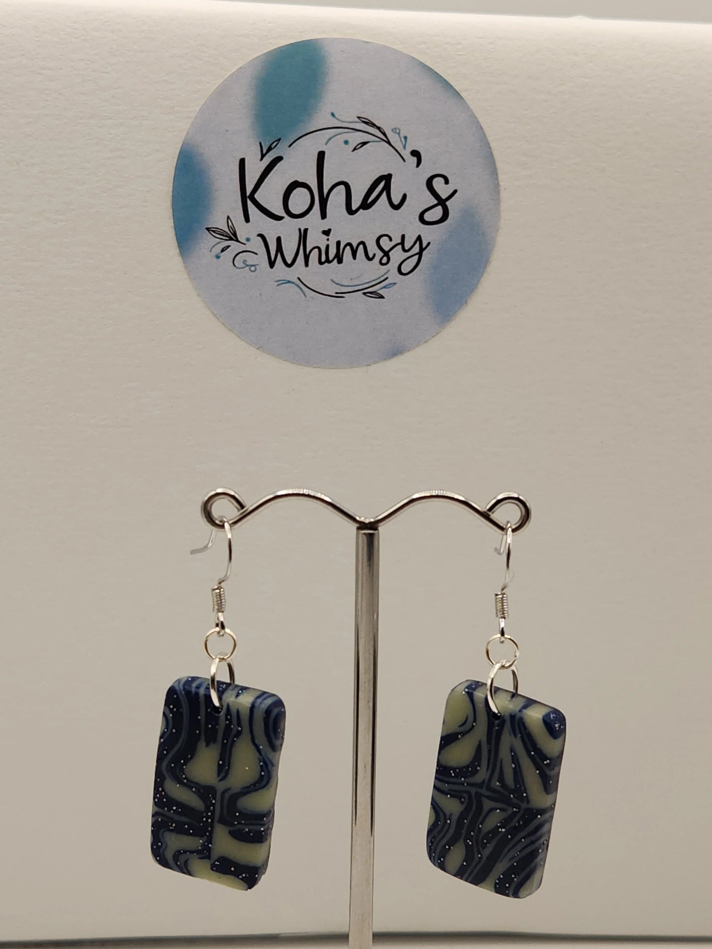 Rectangle dangle earrings with shimmer, by Koha's Whimsy, featuring a blue and tan swirled pattern.
