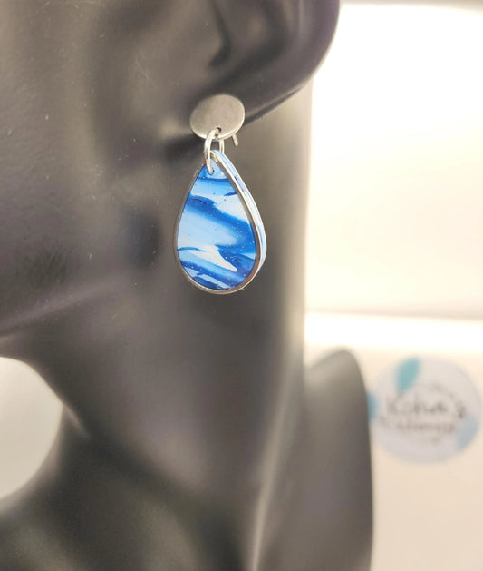 Blue teardrop earrings with silver trim from an unidentified brand, featuring a swirling pattern.