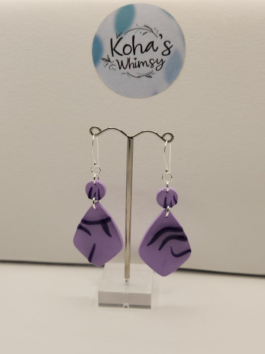 Idol dangle earrings displayed showing artistic KPop-inspired design with demon patterns