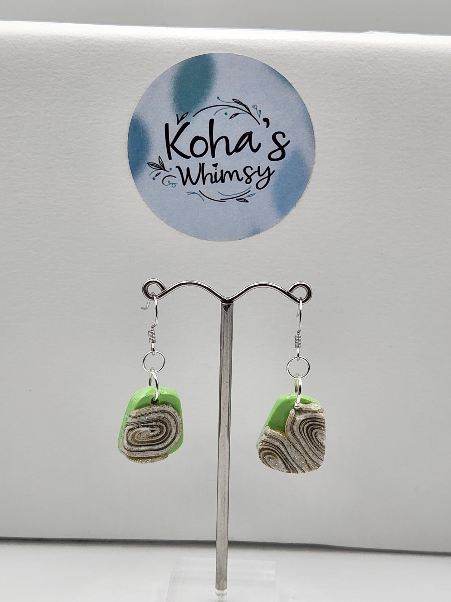 Handmade polymer clay small quadrangle dangle earrings with lime green and cinnamon swirl pattern
