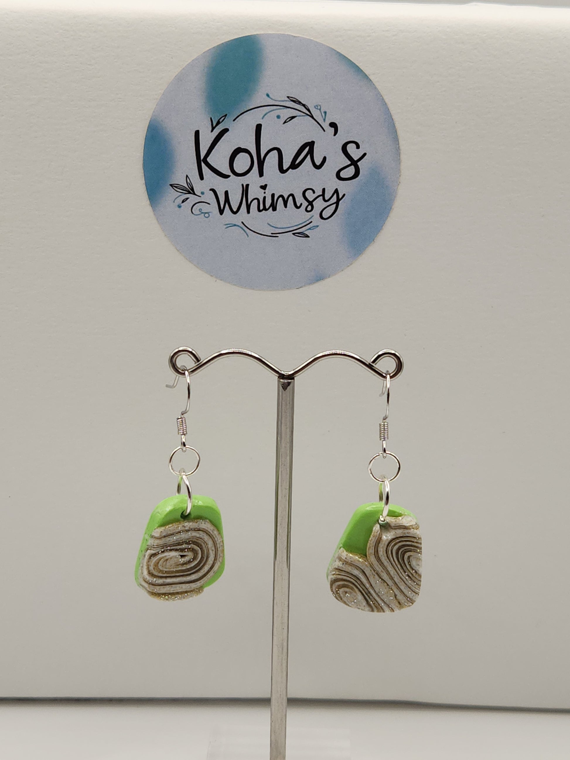 Cinnamon and lime earrings displayed showing modern quadrangle design with green and brown colours