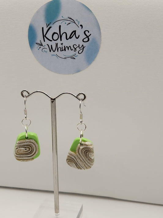 Close-up of cinnamon and lime quadrangle earrings showing geometric shape and vibrant swirls
