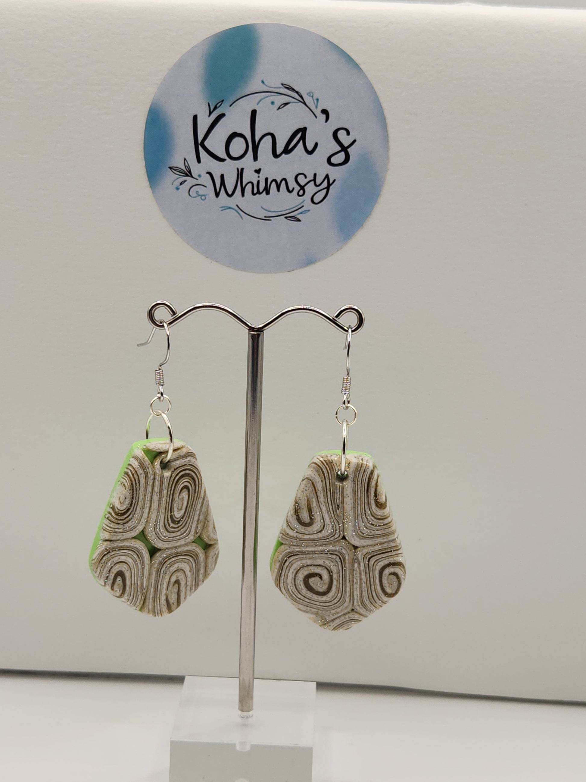 Close-up of cinnamon and lime earrings showing intricate swirl pattern and vibrant colour contrast
