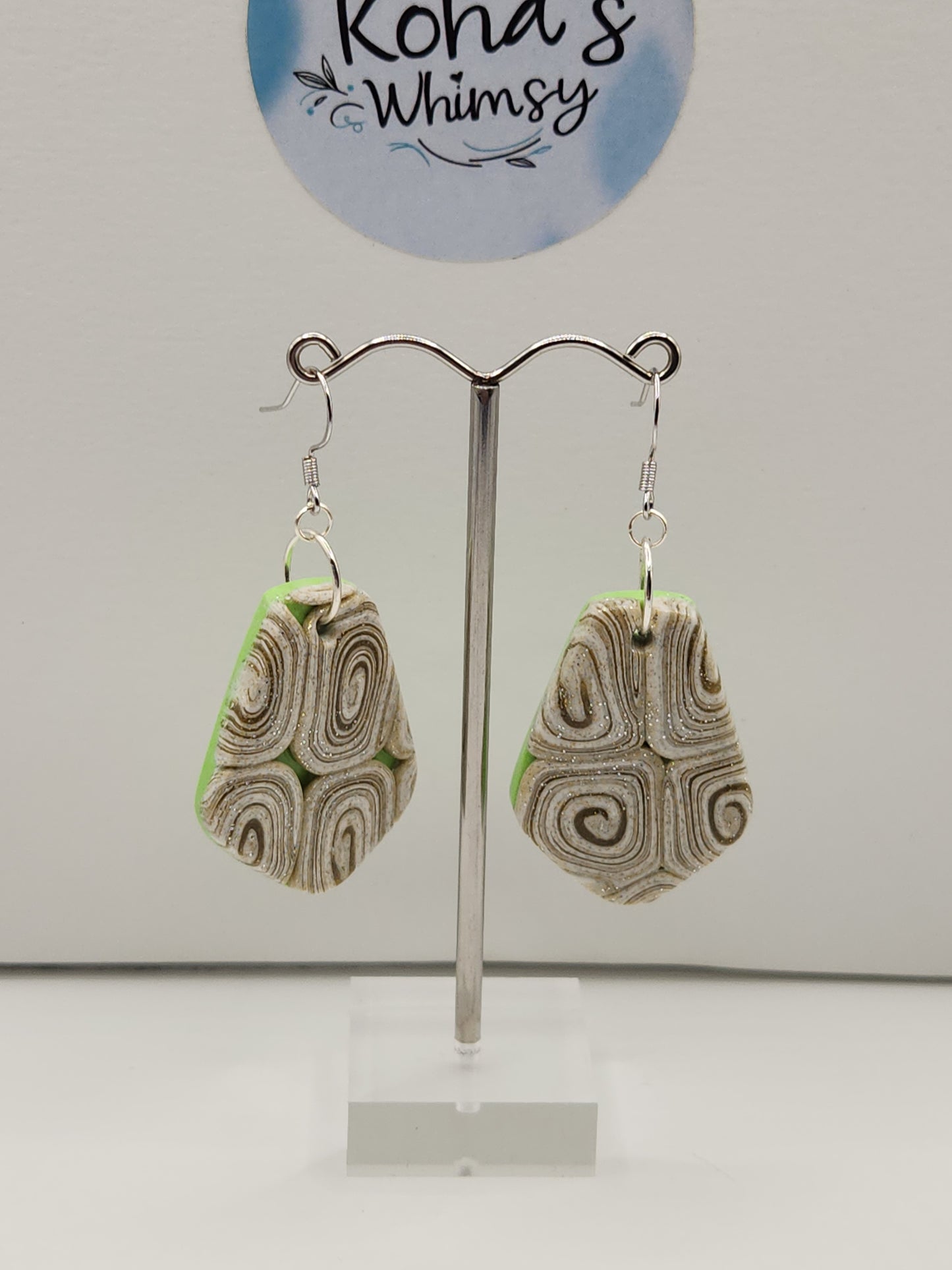Cinnamon and lime drop earrings displayed showing playful modern design with green and brown hues
