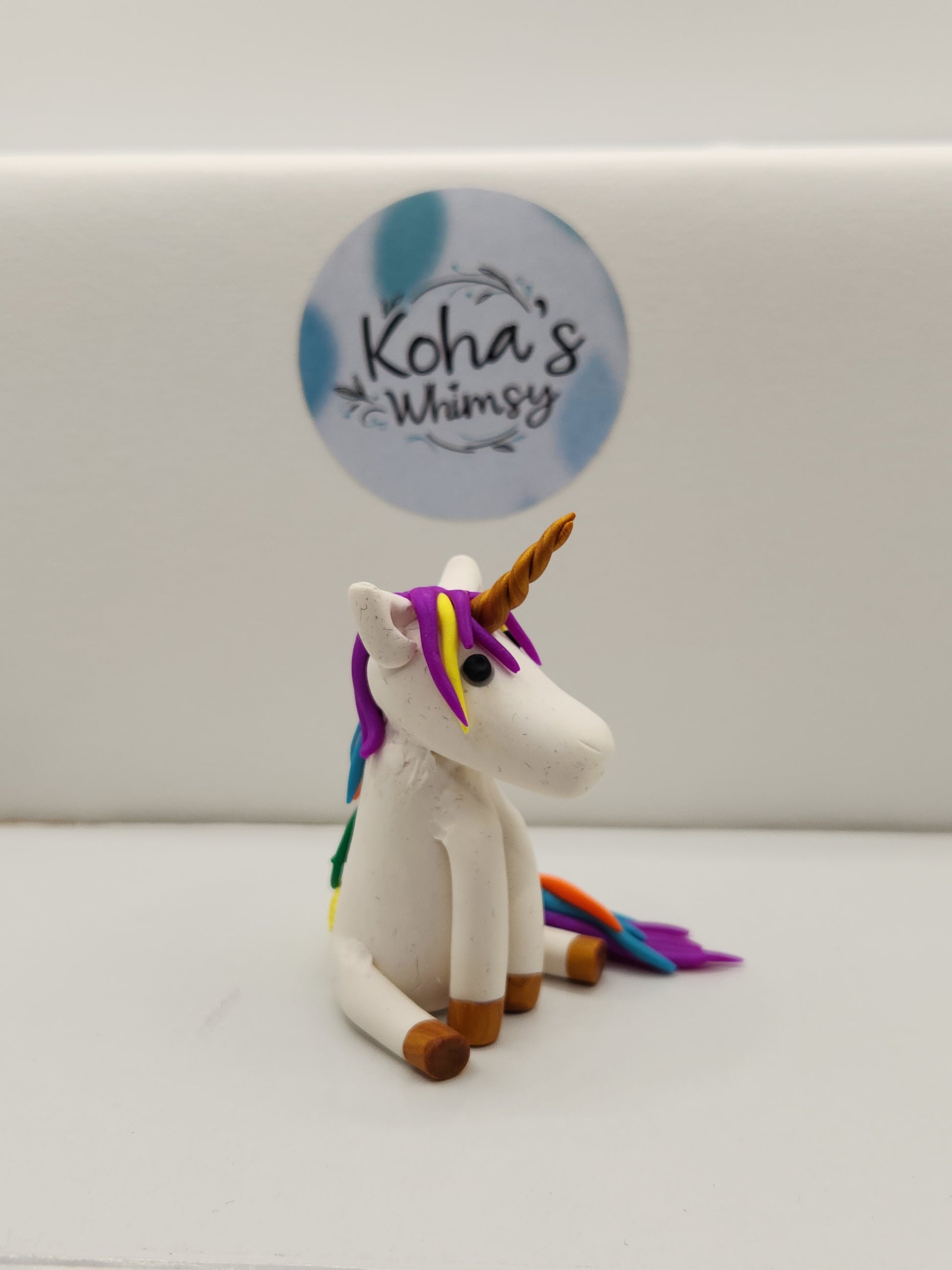 Side view of handmade unicorn figurine Gally displaying artistic polymer clay craftsmanship