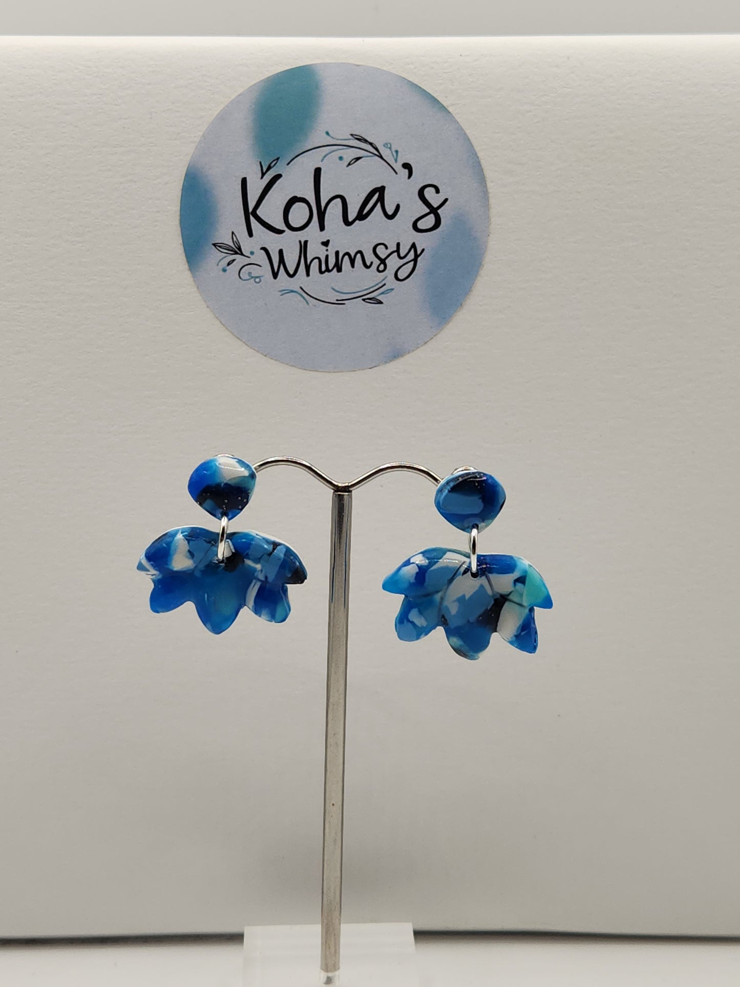 Navy burst lotus bloom stud earrings displayed showing elegant floral pattern and artisan craftsmanship