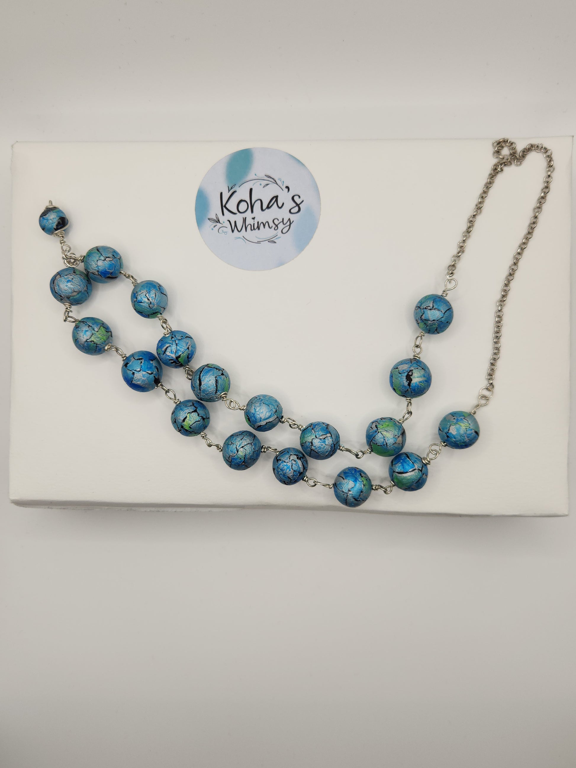 Azure watercolour necklace displayed showing elegant handmade polymer clay bead design