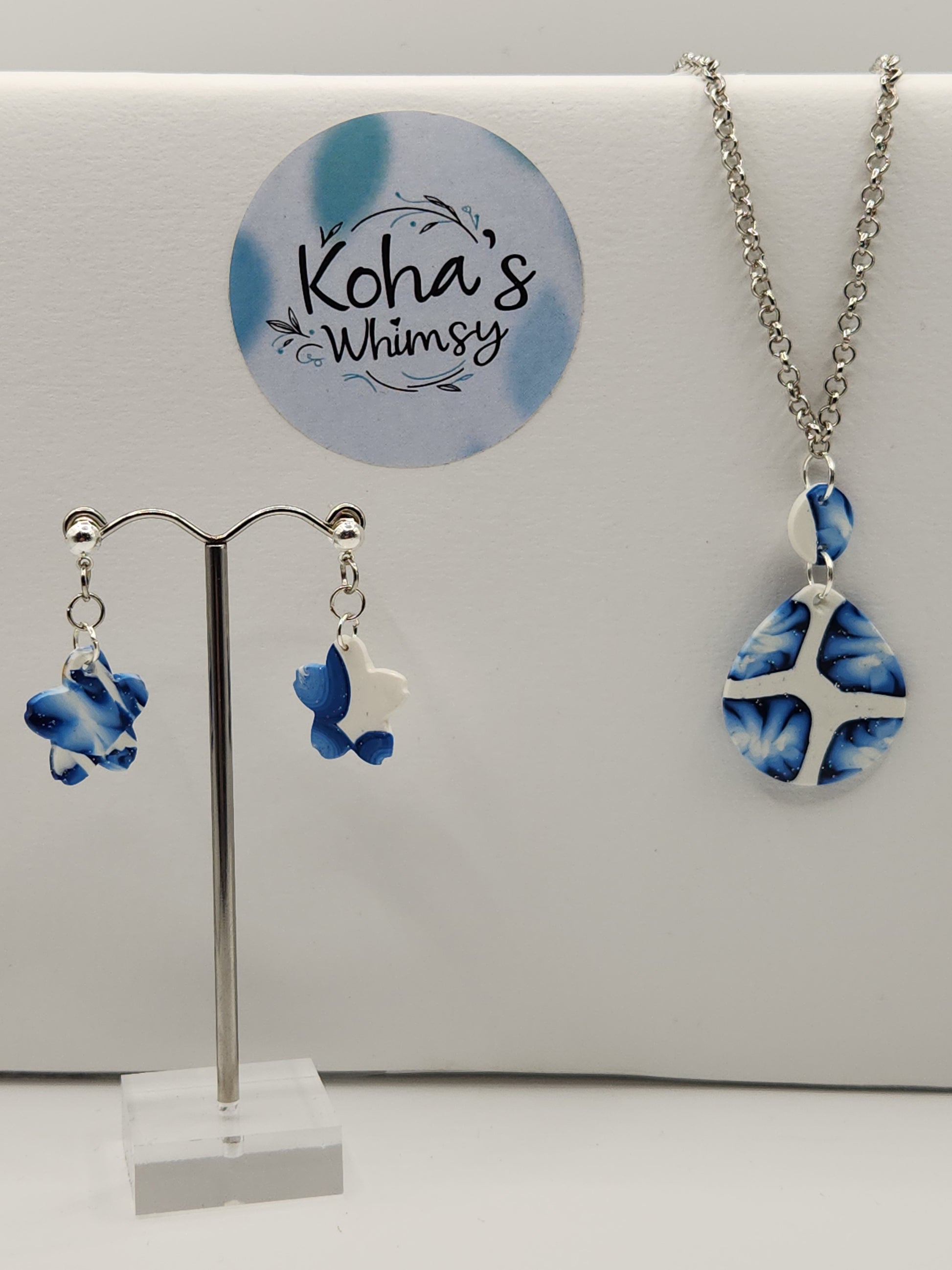 Handmade polymer clay jewellery set with galactic blue shimmer including dangle stud earrings and teardrop pendant necklace