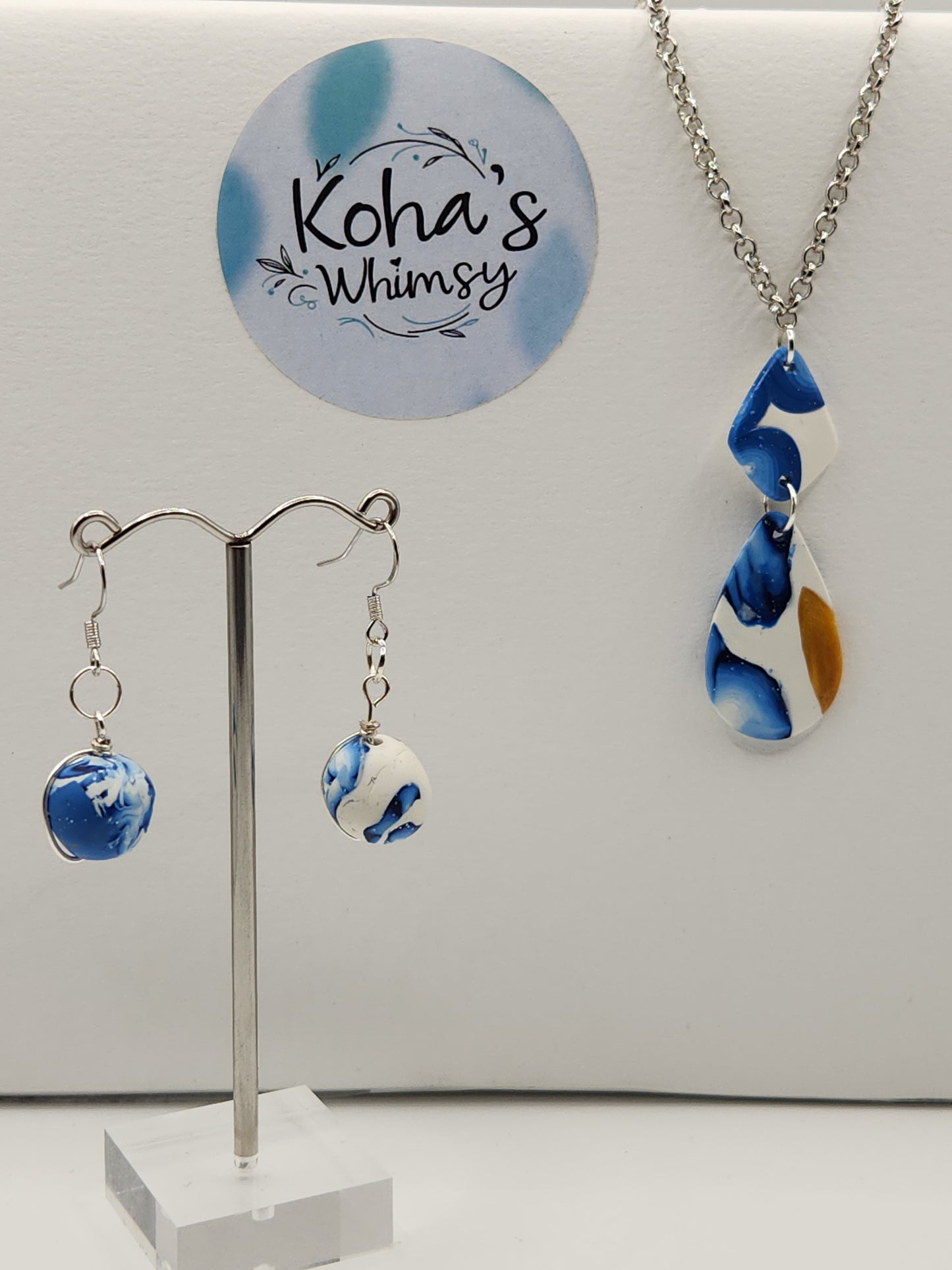 Galactic dreams jewellery set displayed showing cosmic blue design with wire-wrapped earrings and elongated pendant necklace