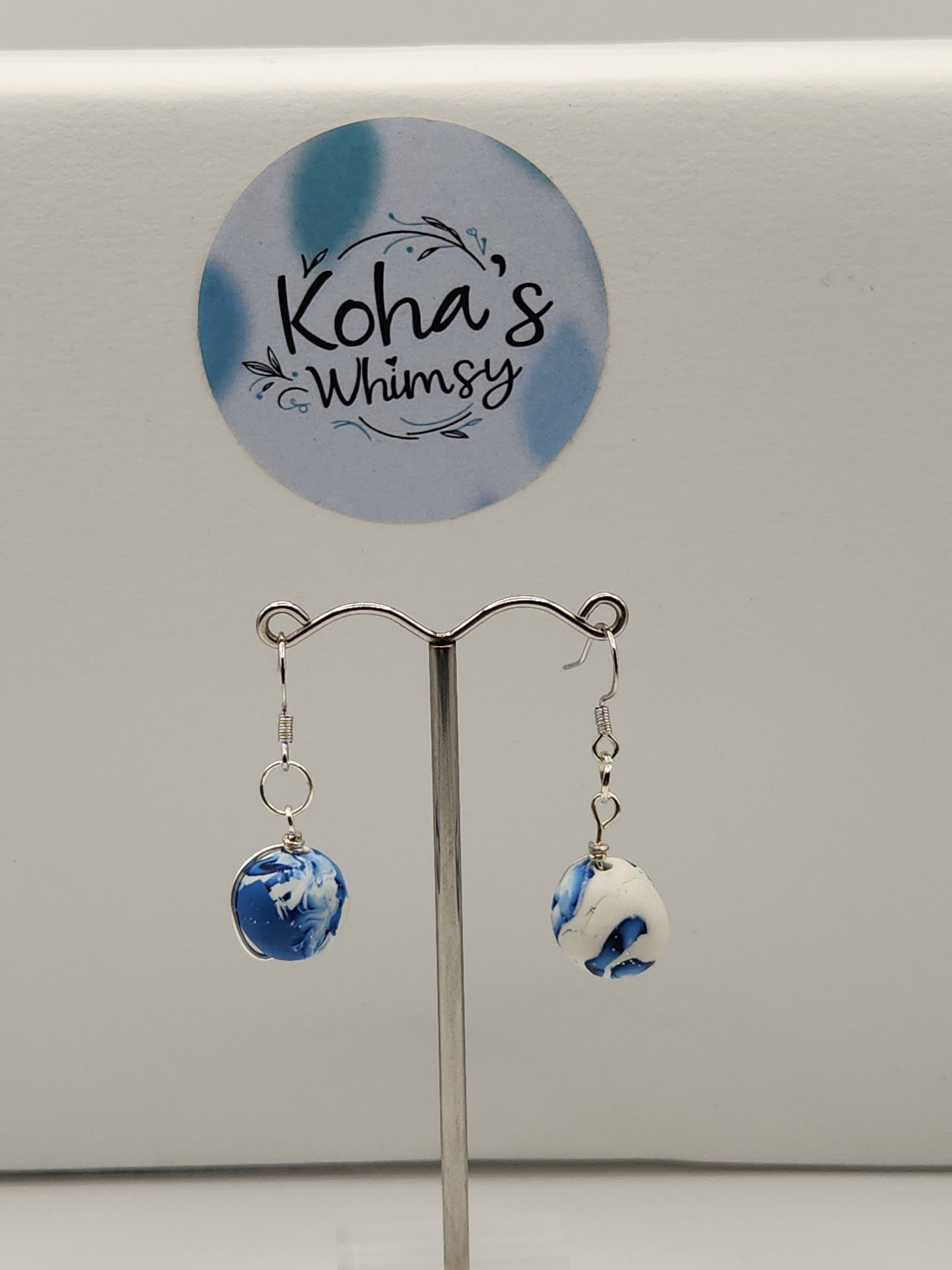 Close-up of galactic dreams set showing wire-wrapped beads and blue gradient shimmer with artisan craftsmanship