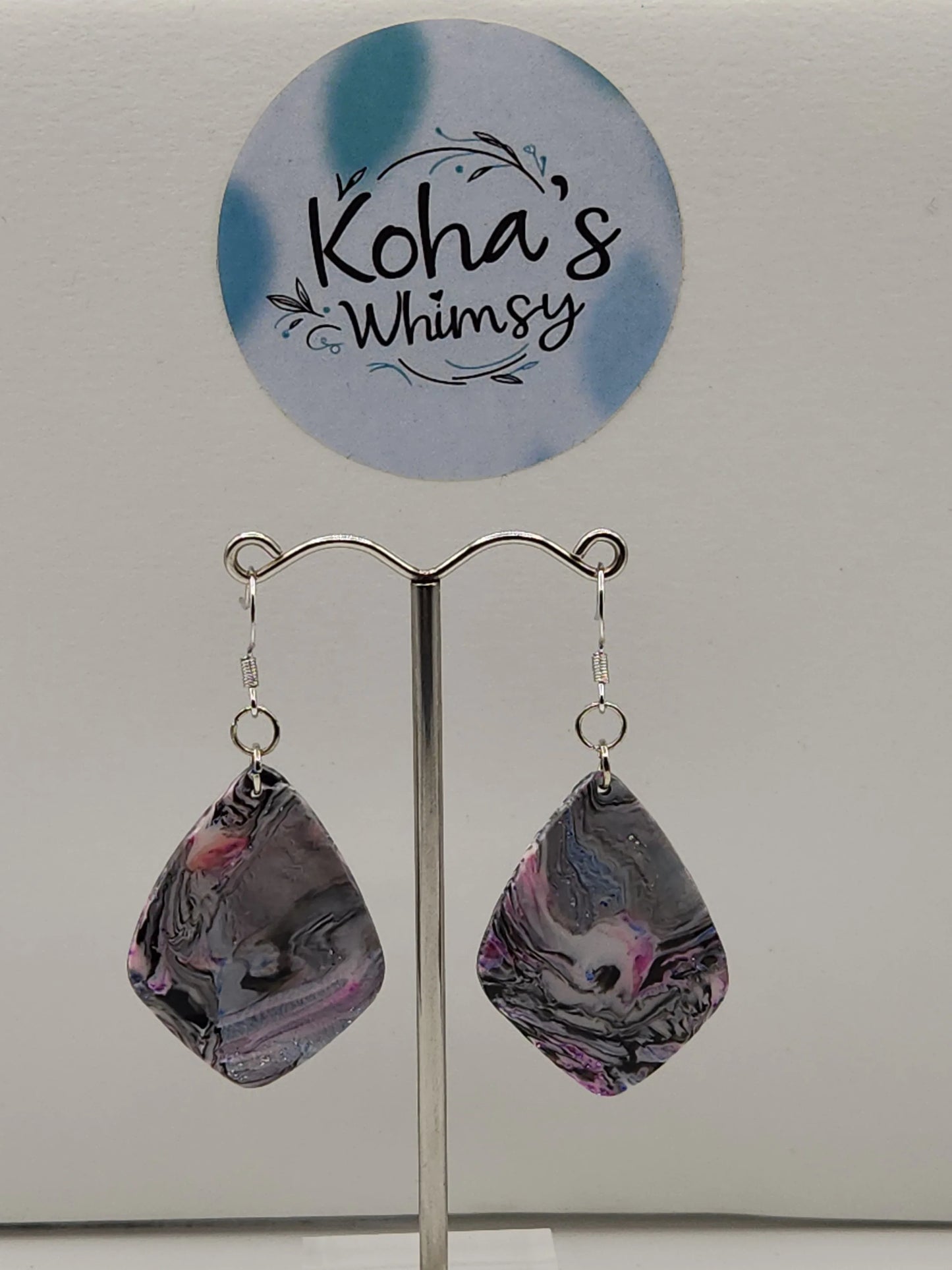 Dangle earrings from Koha's Whimsy in a drop diamond shape with a grey chaotic swirl pattern.