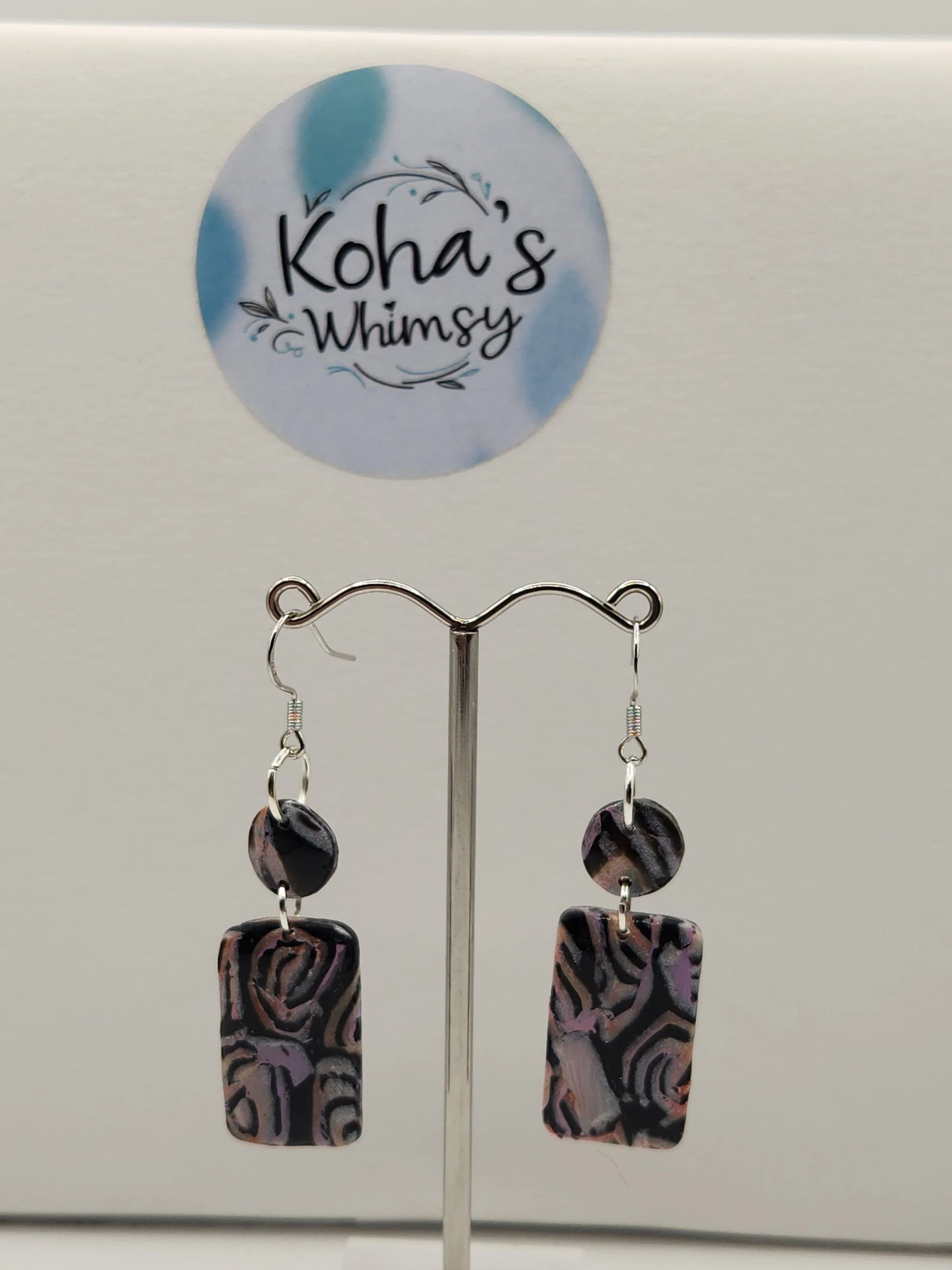 Dangle earrings with pastel swirls by Koha's Whimsy, featuring a small rectangle and circle shape.
