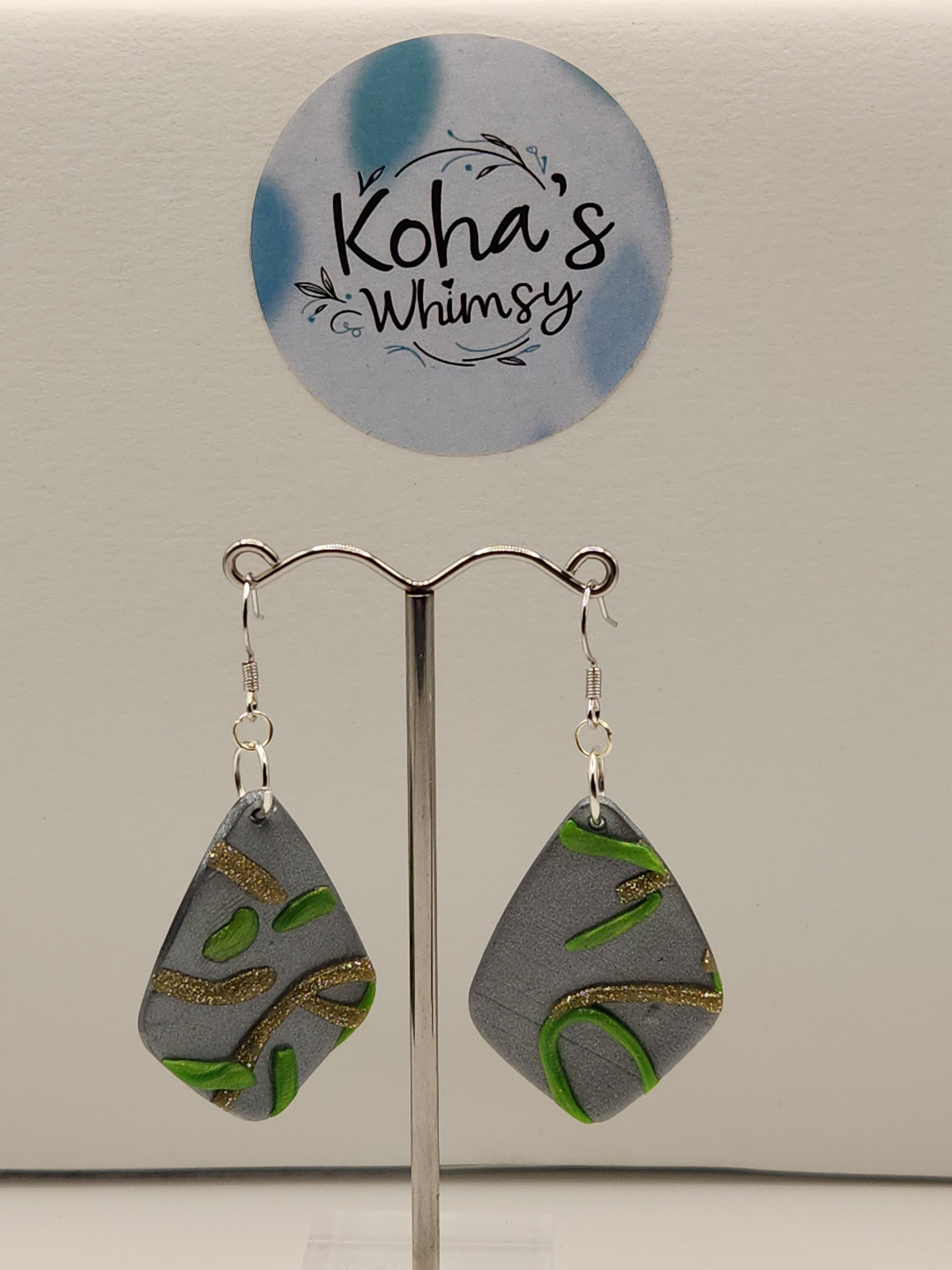 Handmade polymer clay abstract swirls earrings with green and gold design on silver base"
