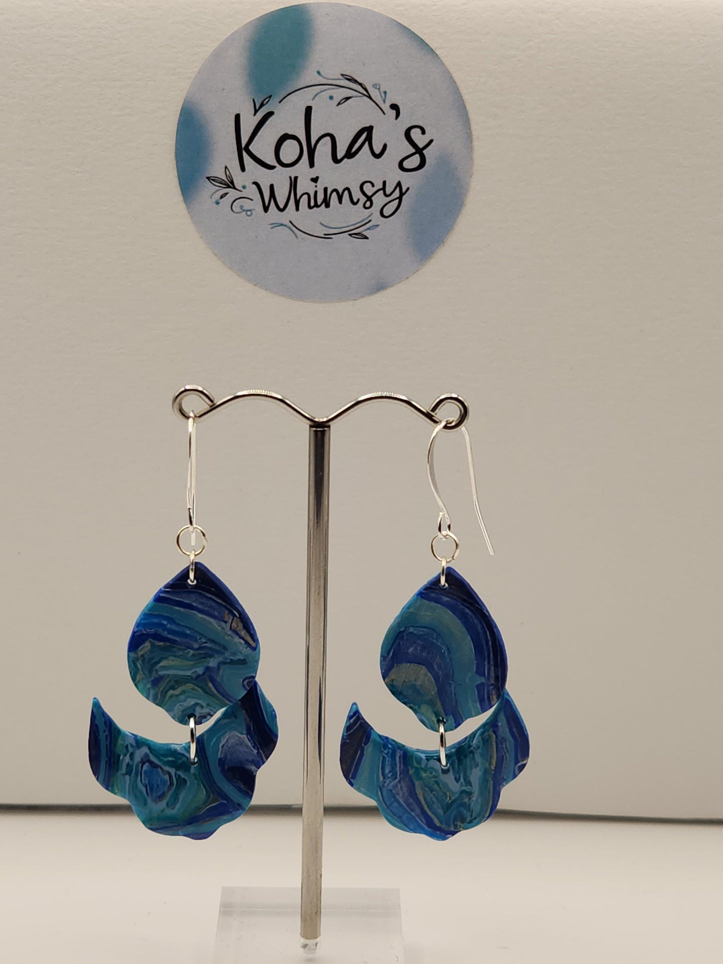 Close-up of blue agate earrings showing natural stone pattern and cascading petal shape
