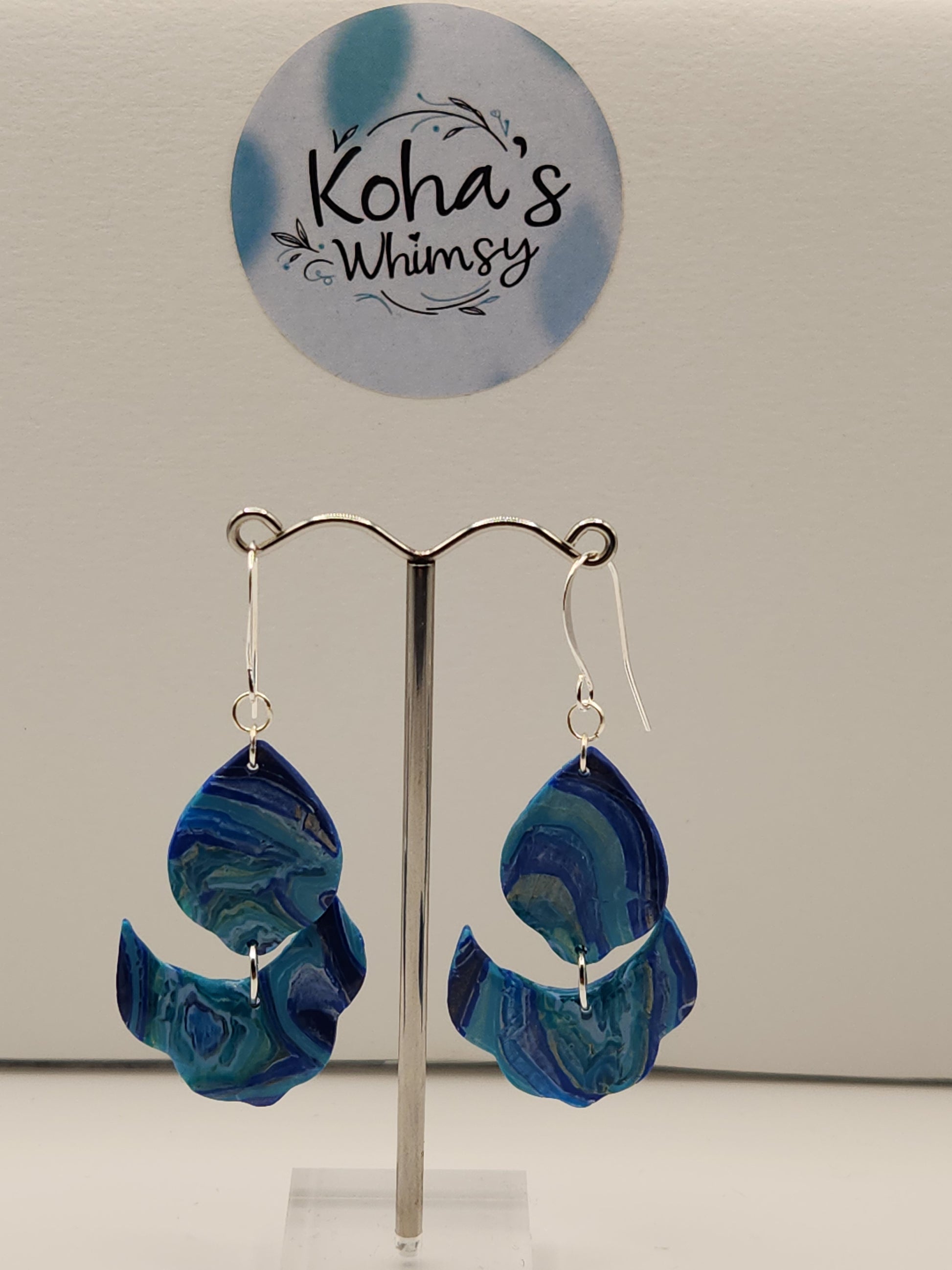 Close-up of blue agate earrings showing natural stone pattern and cascading petal shape

