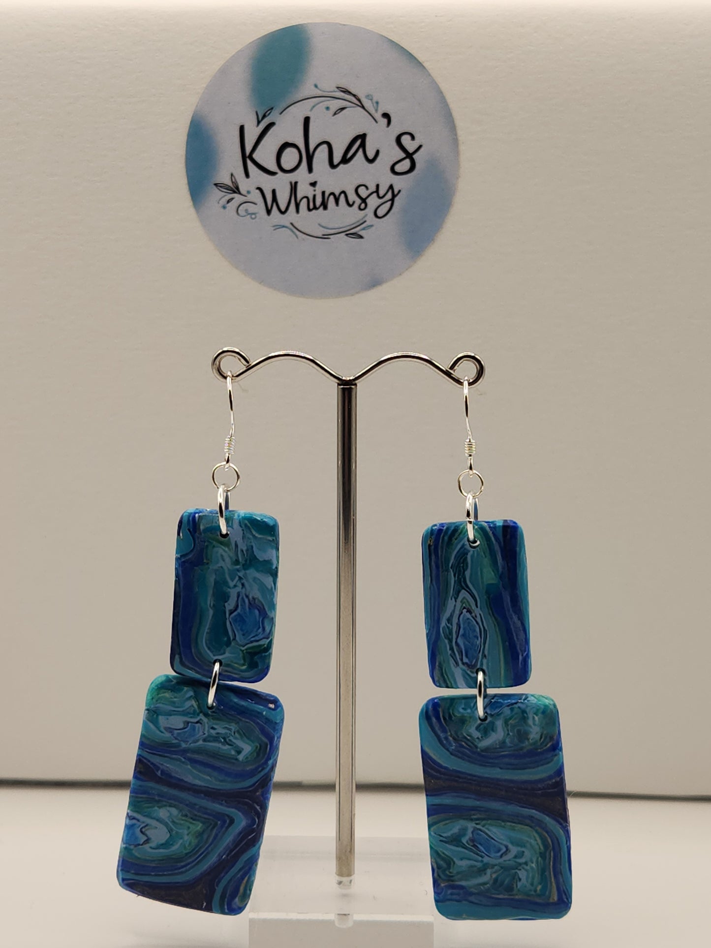Handmade polymer clay rectangle dangle earrings with blue agate pattern and sterling silver hooks

