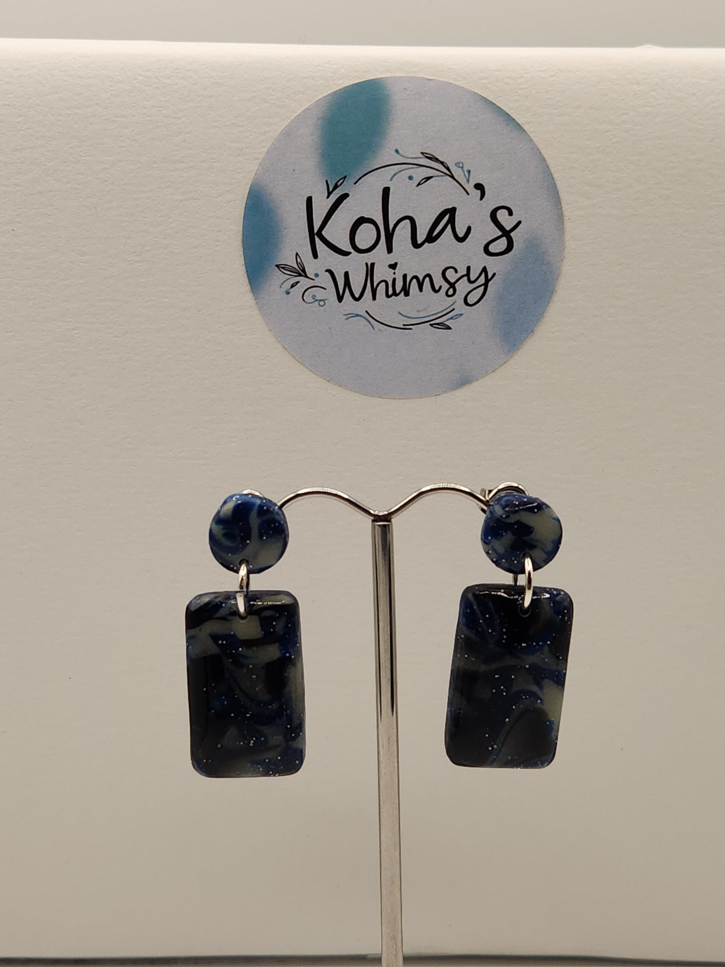 Close-up of glow in the dark rectangle earrings showing sparkle detail