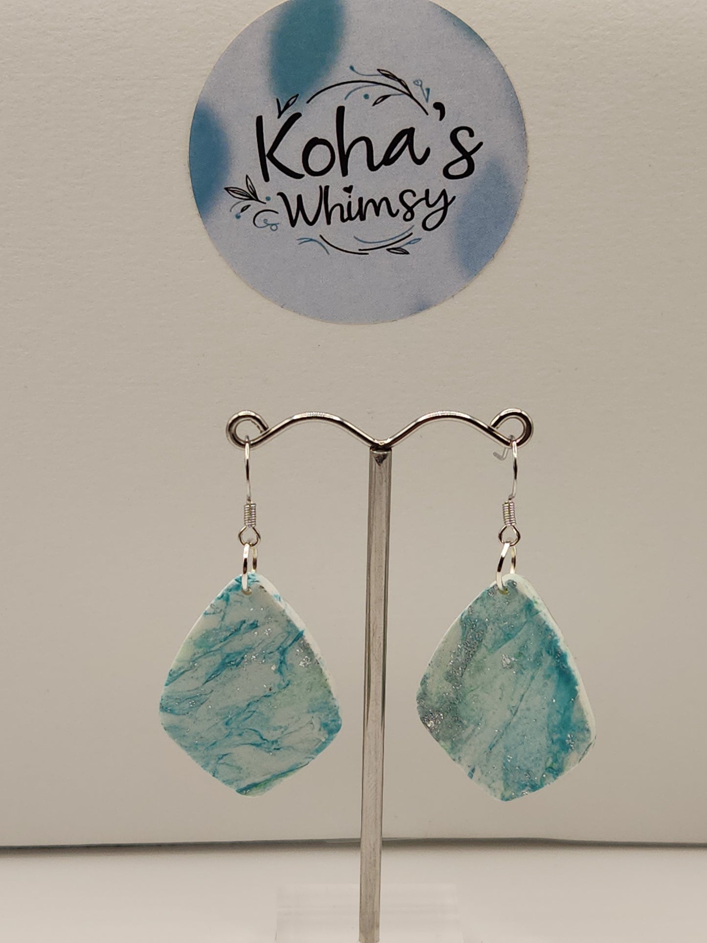 Handmade polymer clay earrings with aqua howlite turquoise marbling pattern