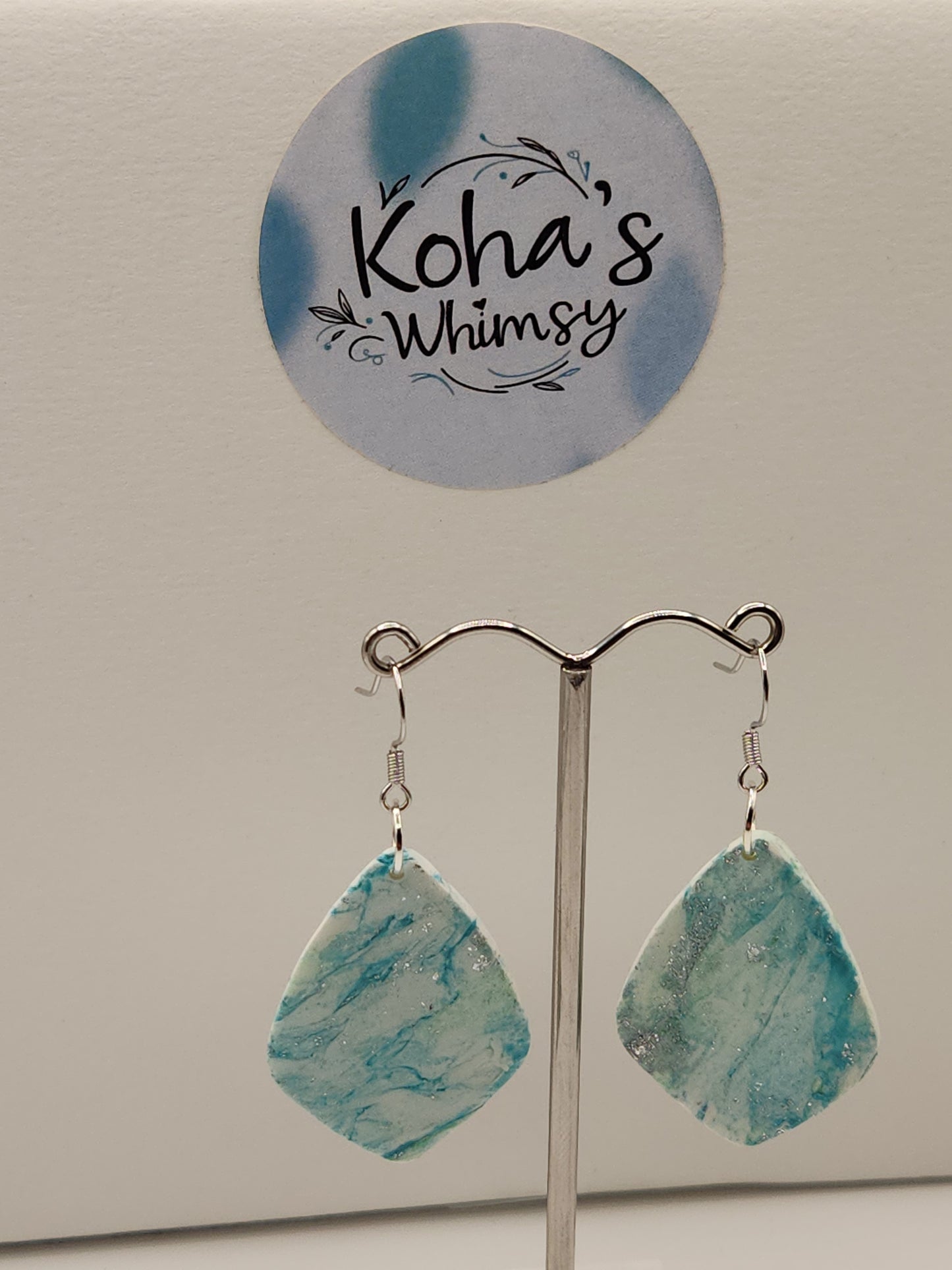 Close-up of aqua howlite earrings showing detailed turquoise and white swirls