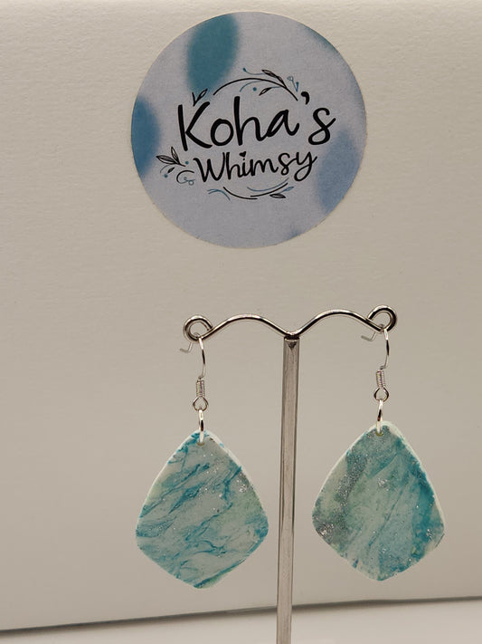 Close-up of aqua howlite earrings showing detailed turquoise and white swirls