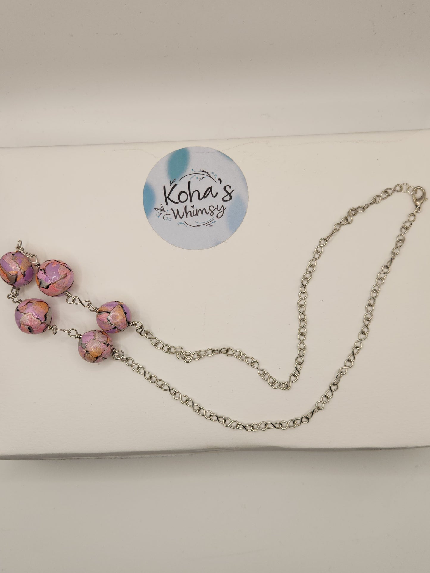 Pastel watercolour beaded necklace displayed showing soft colour palette and unique handcrafted design