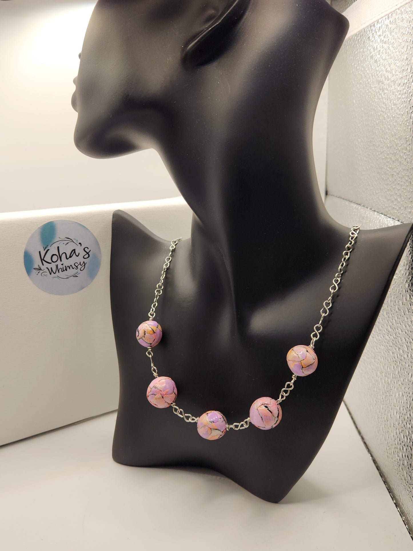 Close-up of pastel watercolour beaded necklace showing delicate watercolour-inspired tones and artisan craftsmanship