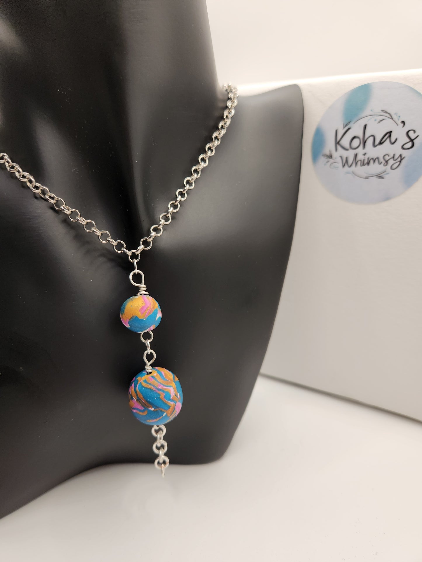 Close-up of unique wire-wrapped necklace showing intricate coiled wire detail and colourful beads

