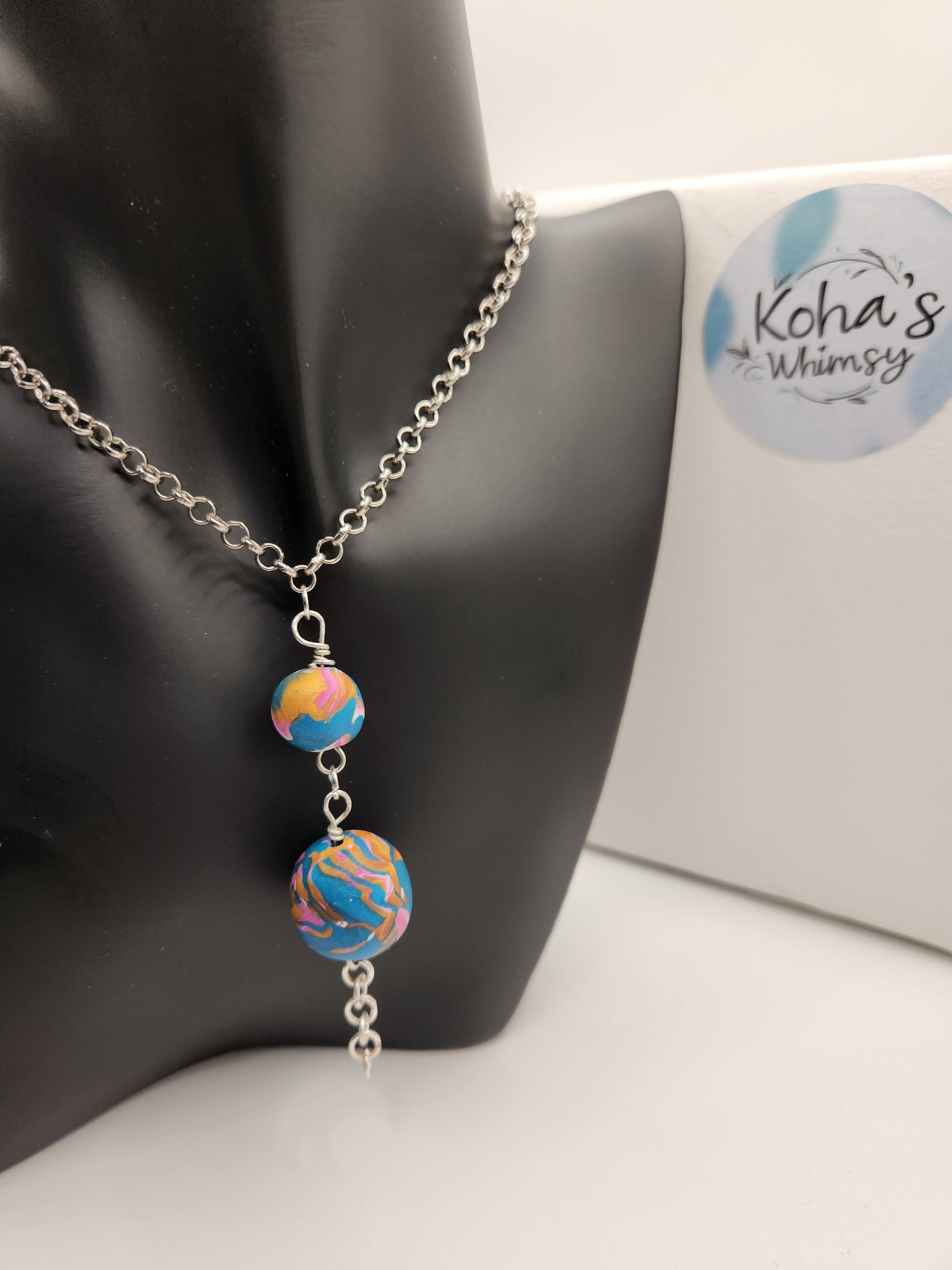 Close-up of unique wire-wrapped necklace showing intricate coiled wire detail and colourful beads

