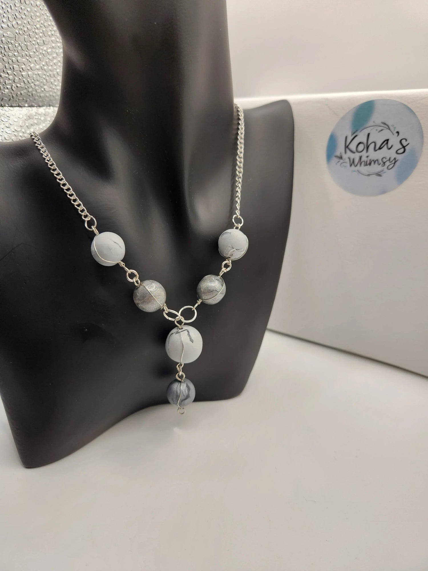 Silver beaded necklace by Koha's Whimsy with grey and marble colored beads on a silver chain.