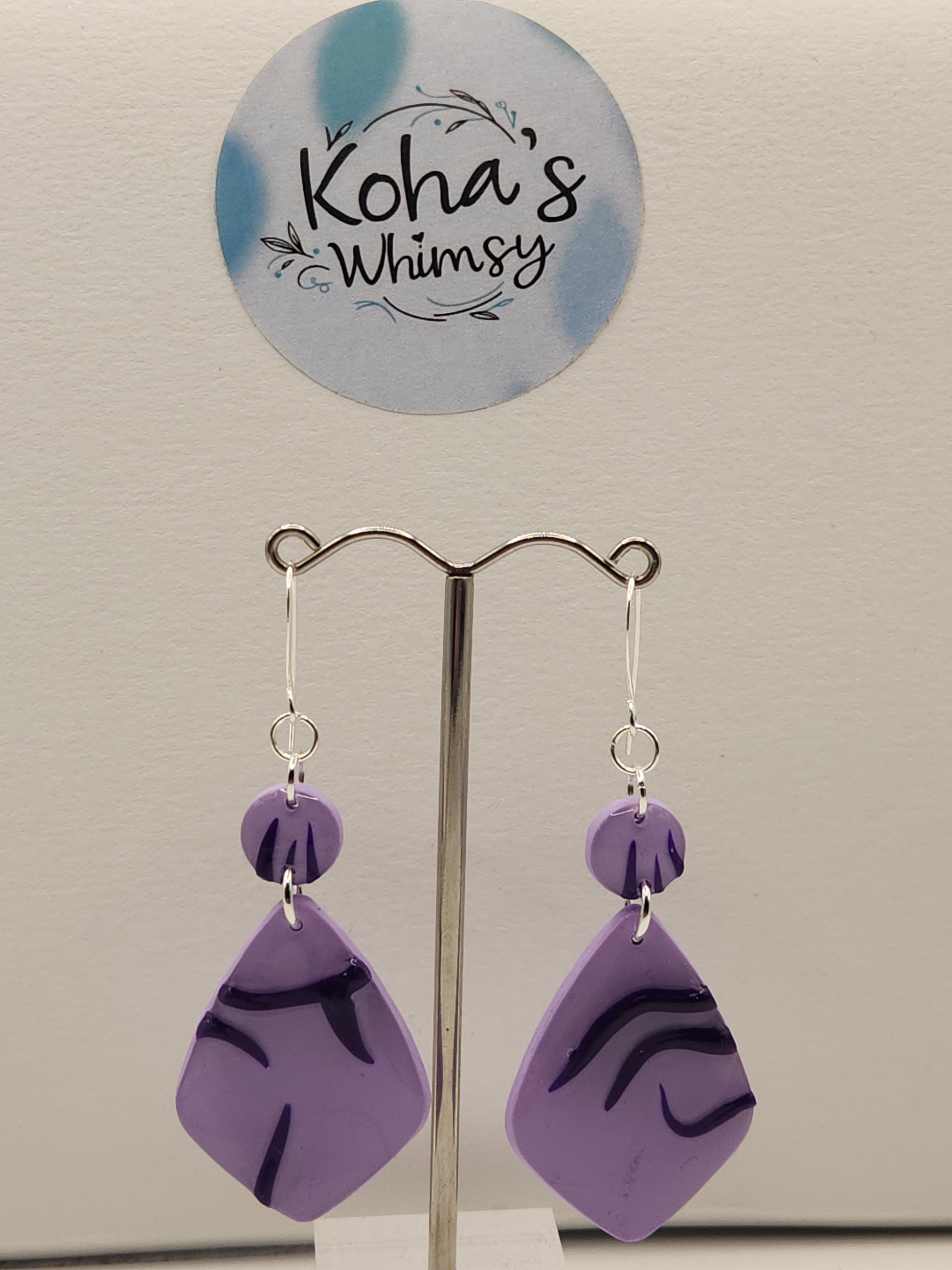 Close-up of idol earrings showing unique demon pattern inspired by Jinu from KPop Demon Hunters
