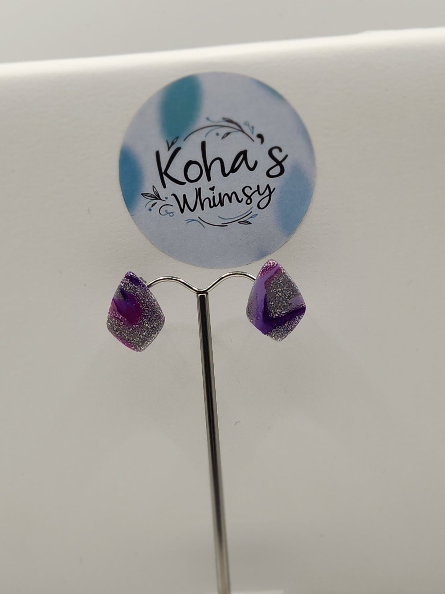 Purple droplets drop diamond stud earrings displayed showing unique artistic design and elegant style