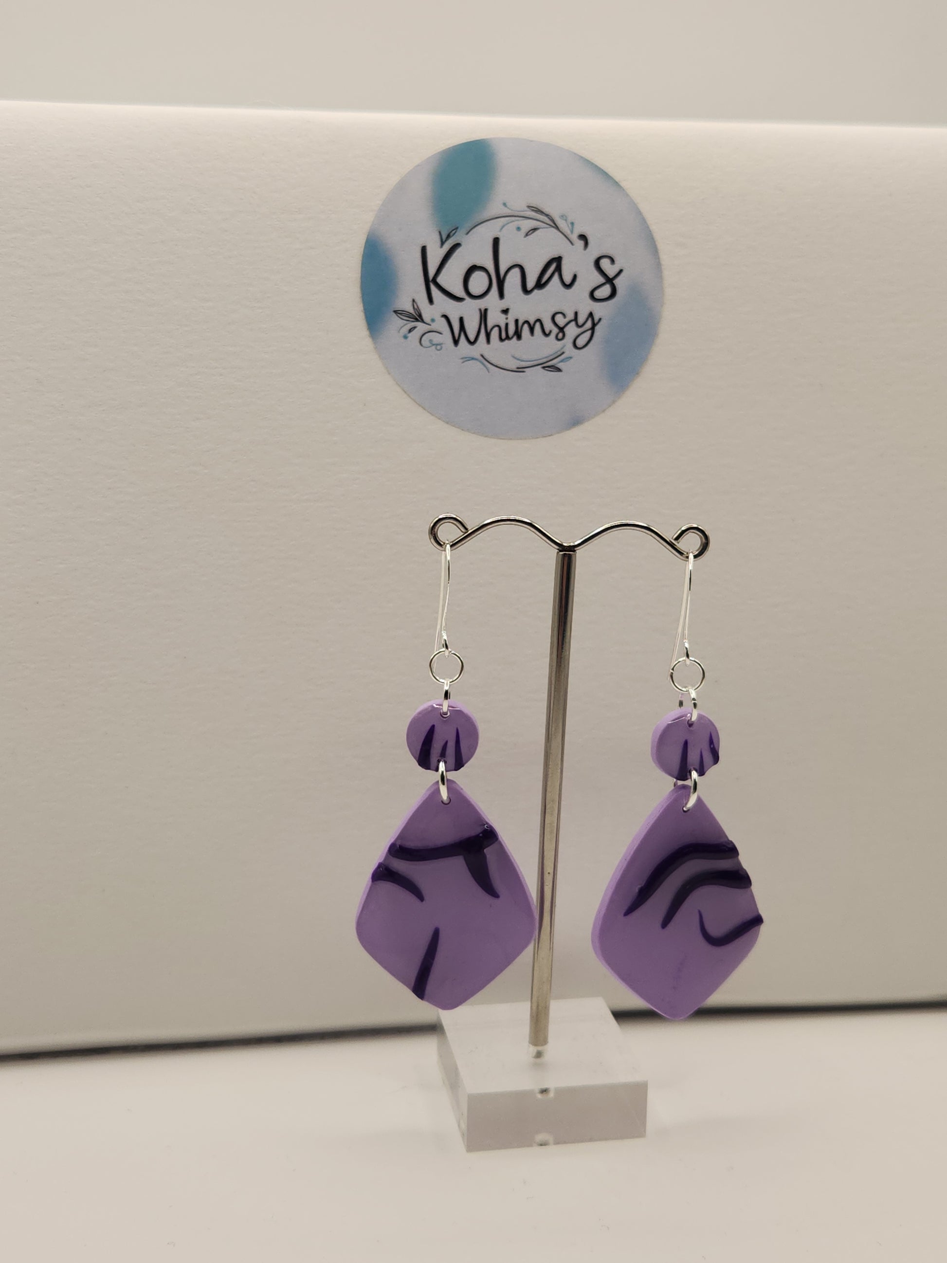 Handmade polymer clay idol earrings inspired by KPop Demon Hunters with demon pattern design
